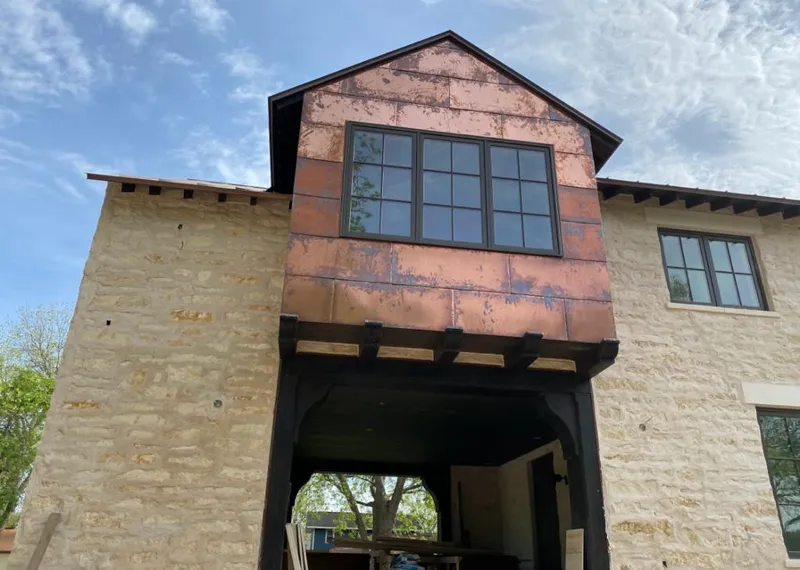 Copper metal panel facade on a stone building for Skylight Installation in North Caldwell